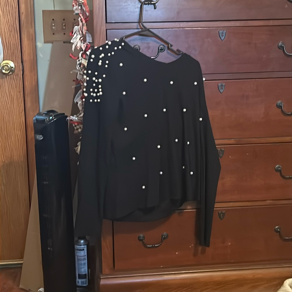 A cute pearl and black sweater for any occasion